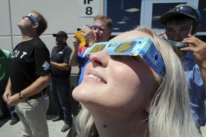 women viewing solar eclipse