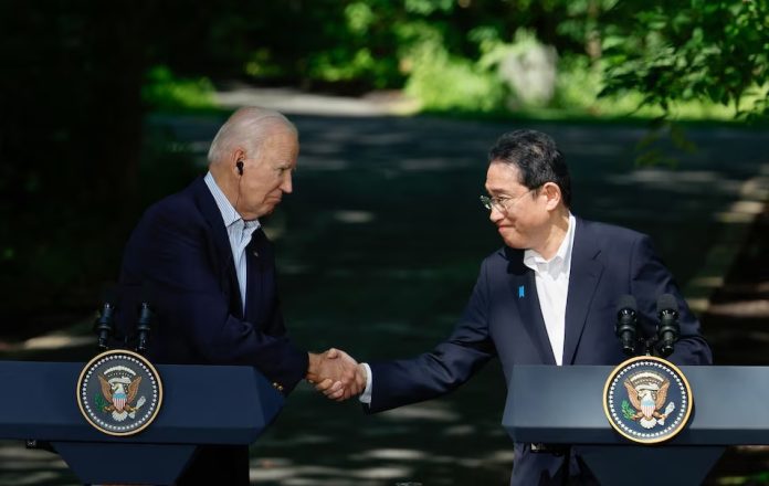 Japanese Prime Minister Fumio Kishida shakes hands with U.S. President Joe Biden